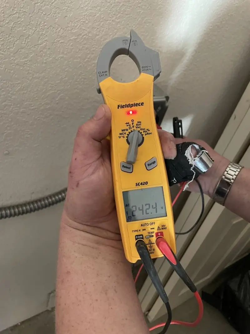 Voltage testing with clamp meter during Outlet Installation in Colesville
